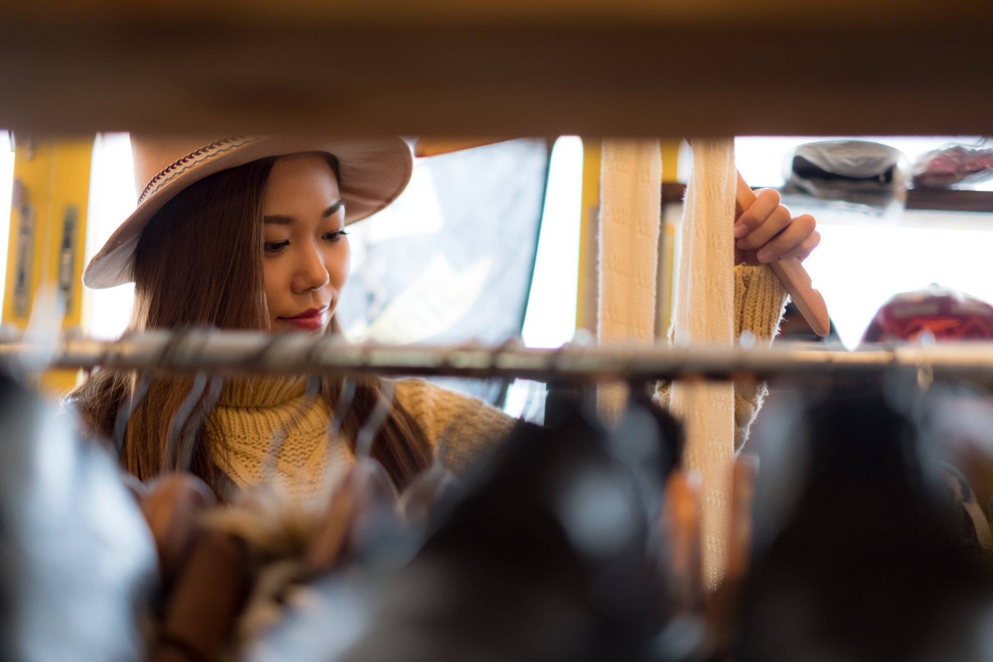 A woman enjoying casual clothes shopping in a clothing store.