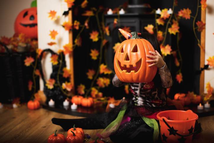 Toddler girl dressed up playing in Halloween party